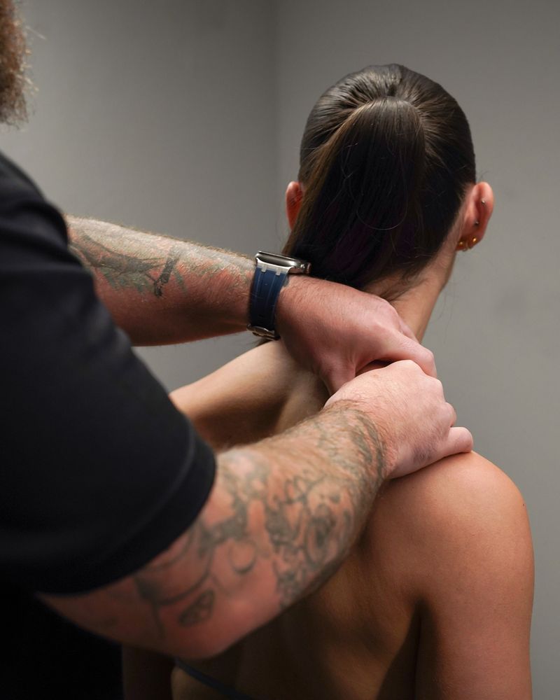 Kieran assessing a patient's shoulder